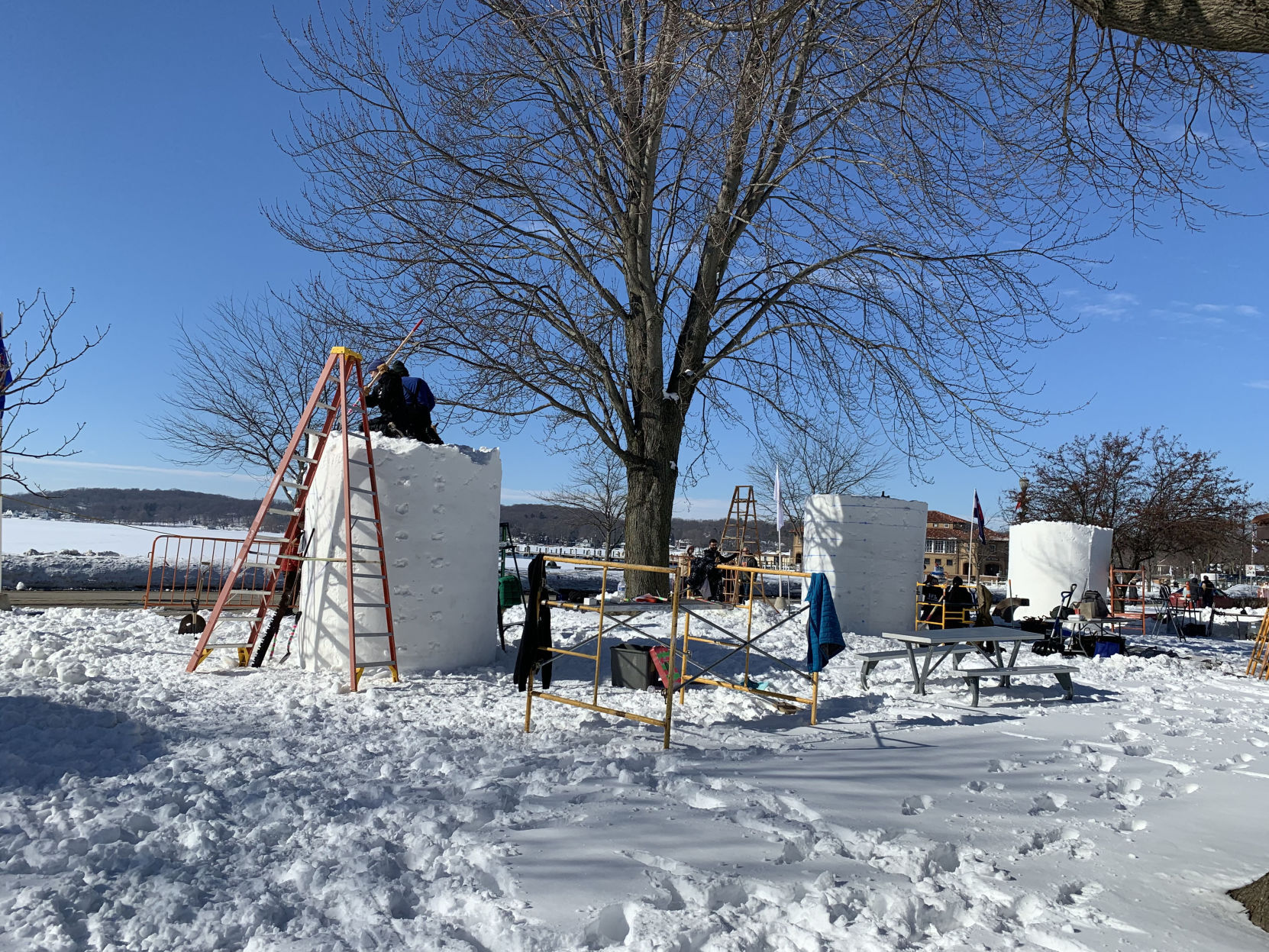 Teams begin to work on their sculptures at Flat Iron Park as part of the kick off to the National Snow Sculpting Competition